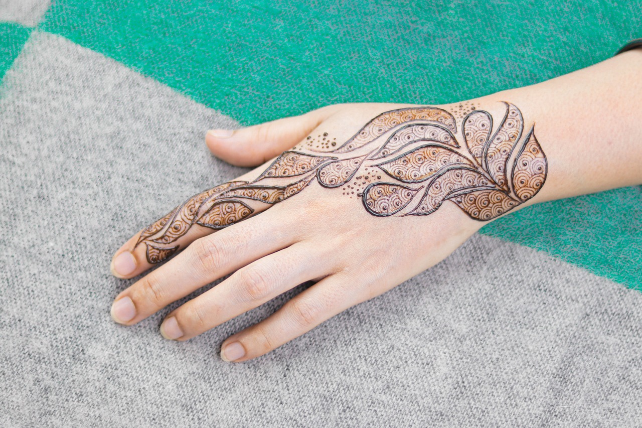 tattoo artist creating fine line botanical tattoo