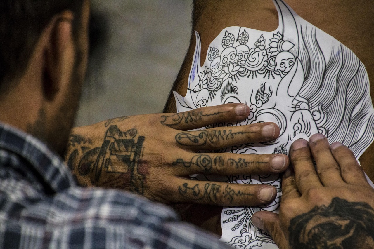 tattoo artist discussing design with client