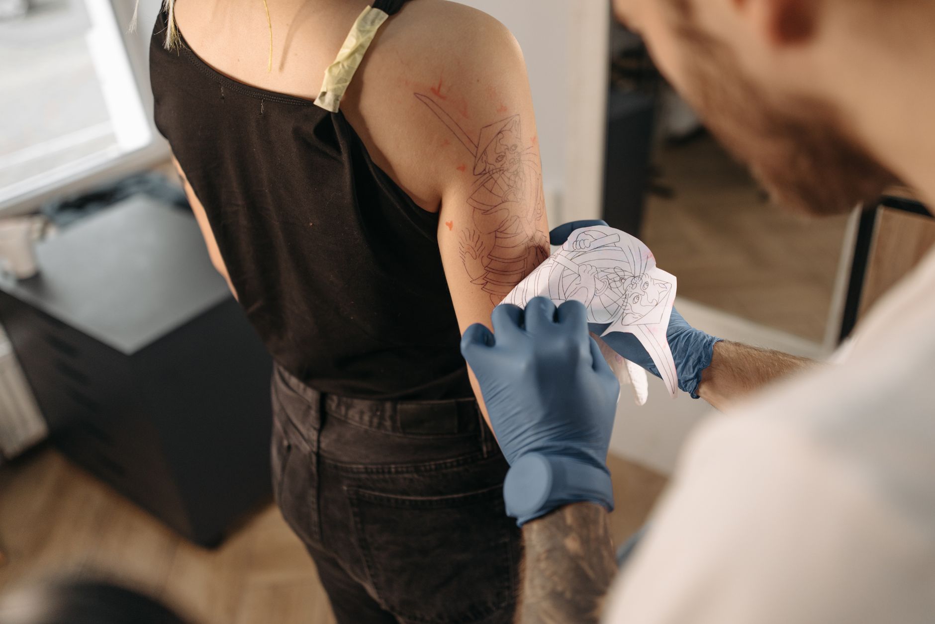 tattoo artist preparing stencil